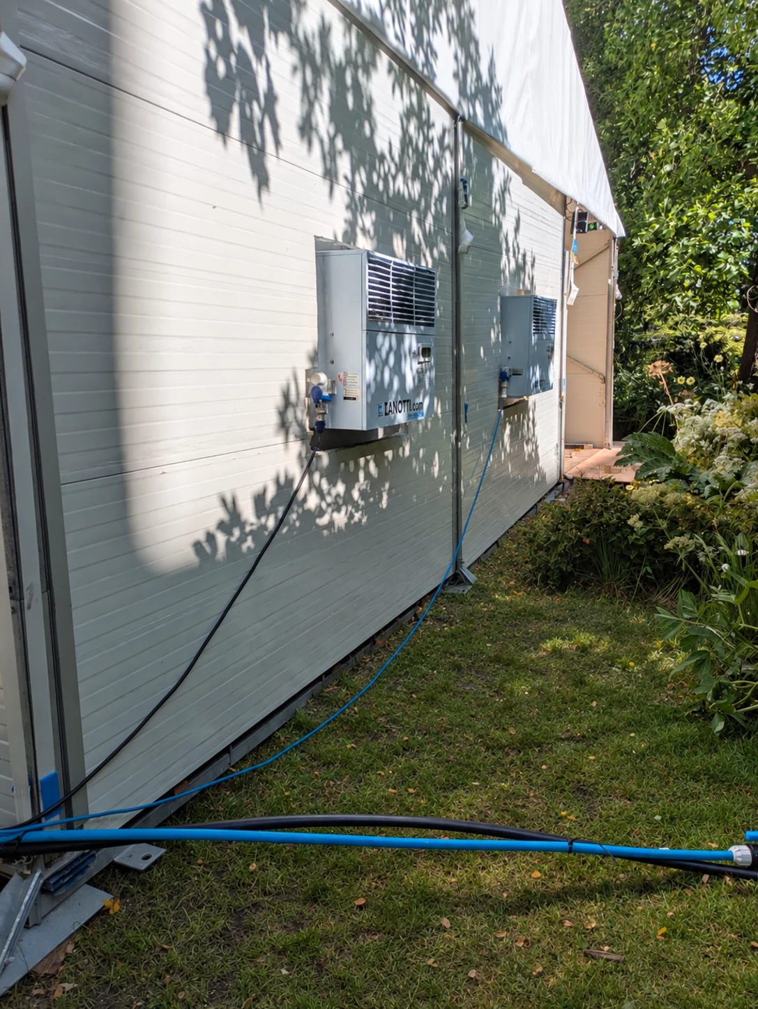 Two refrigeration motors projecting through the marquee wall to discharge warm air outdoors