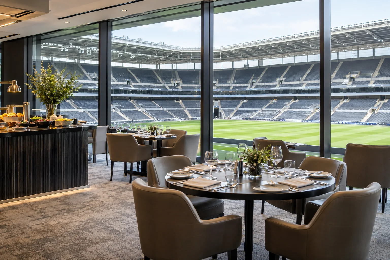Stadium hospitality dining area overlooking a football pitch